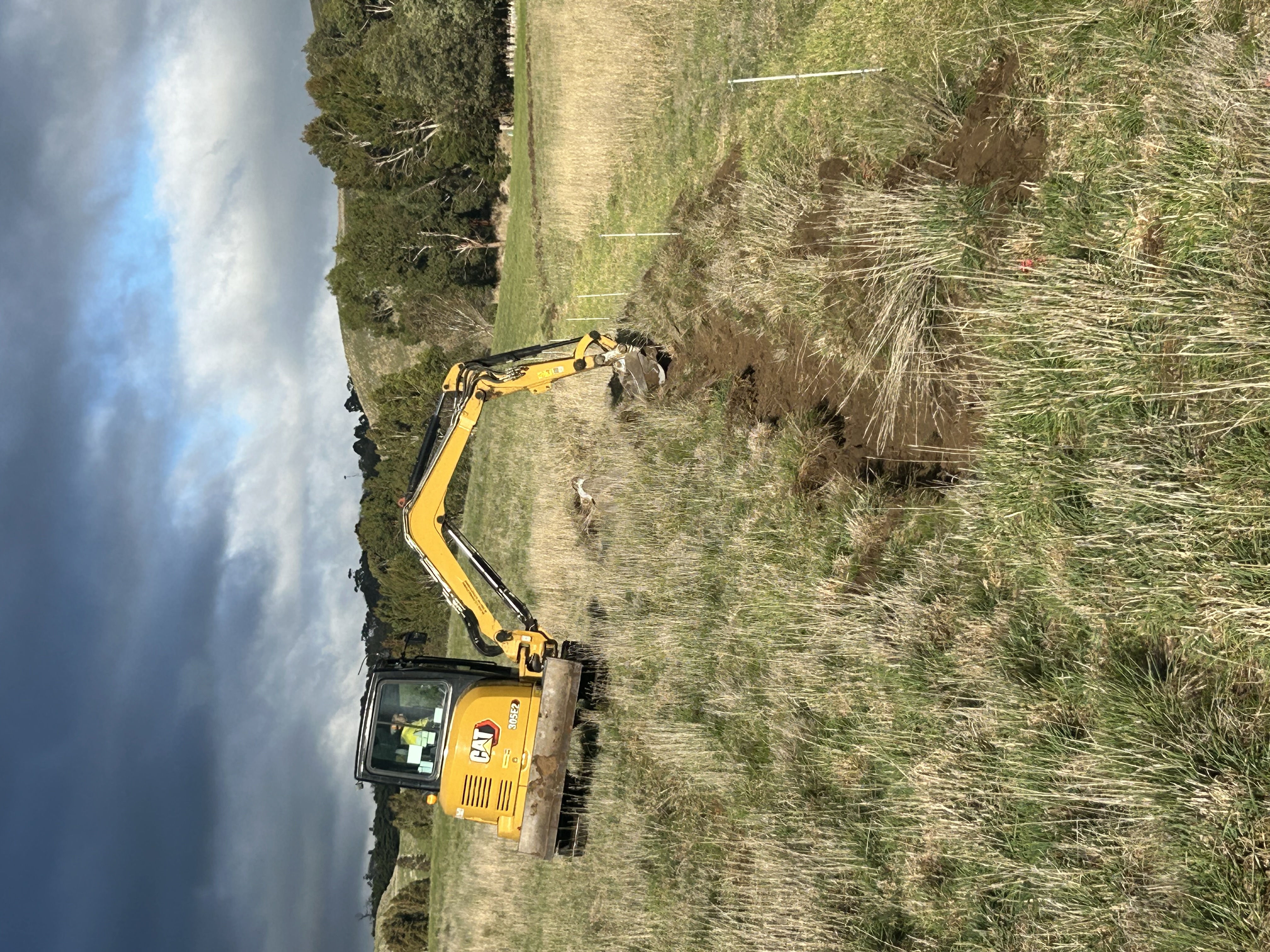 Excavator digging contour swales at The Farm at Mirrim Wurnit